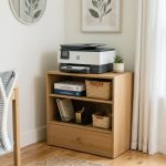 A modern wooden printer stand with shelves organizing neatly stacked paper and office supplies.