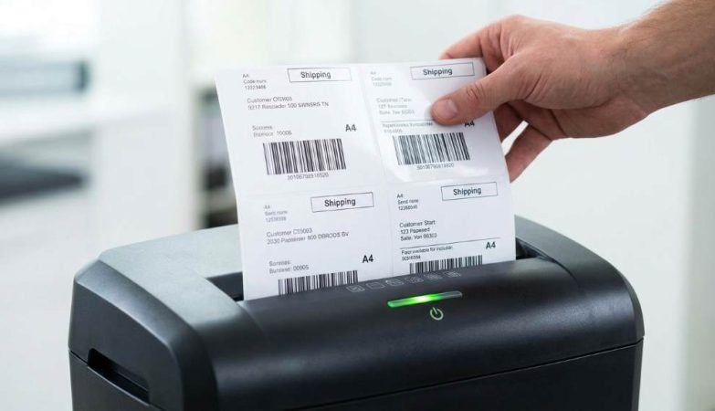 Paper shredder with adhesive residue on cutting blades